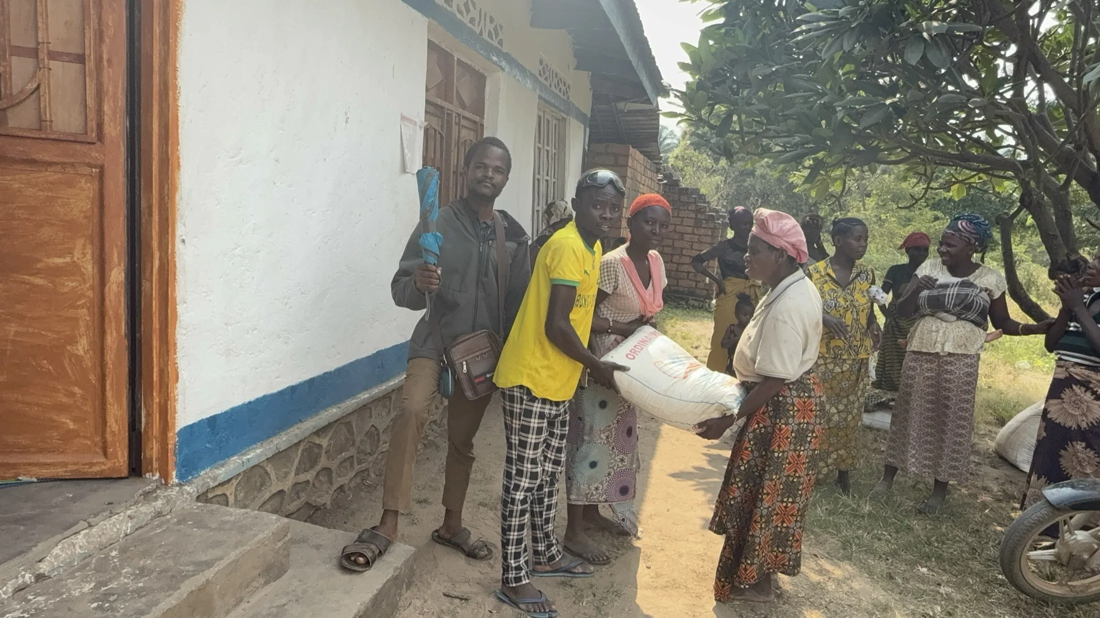 Widows and neighbors receive flour at our church in DR Congo