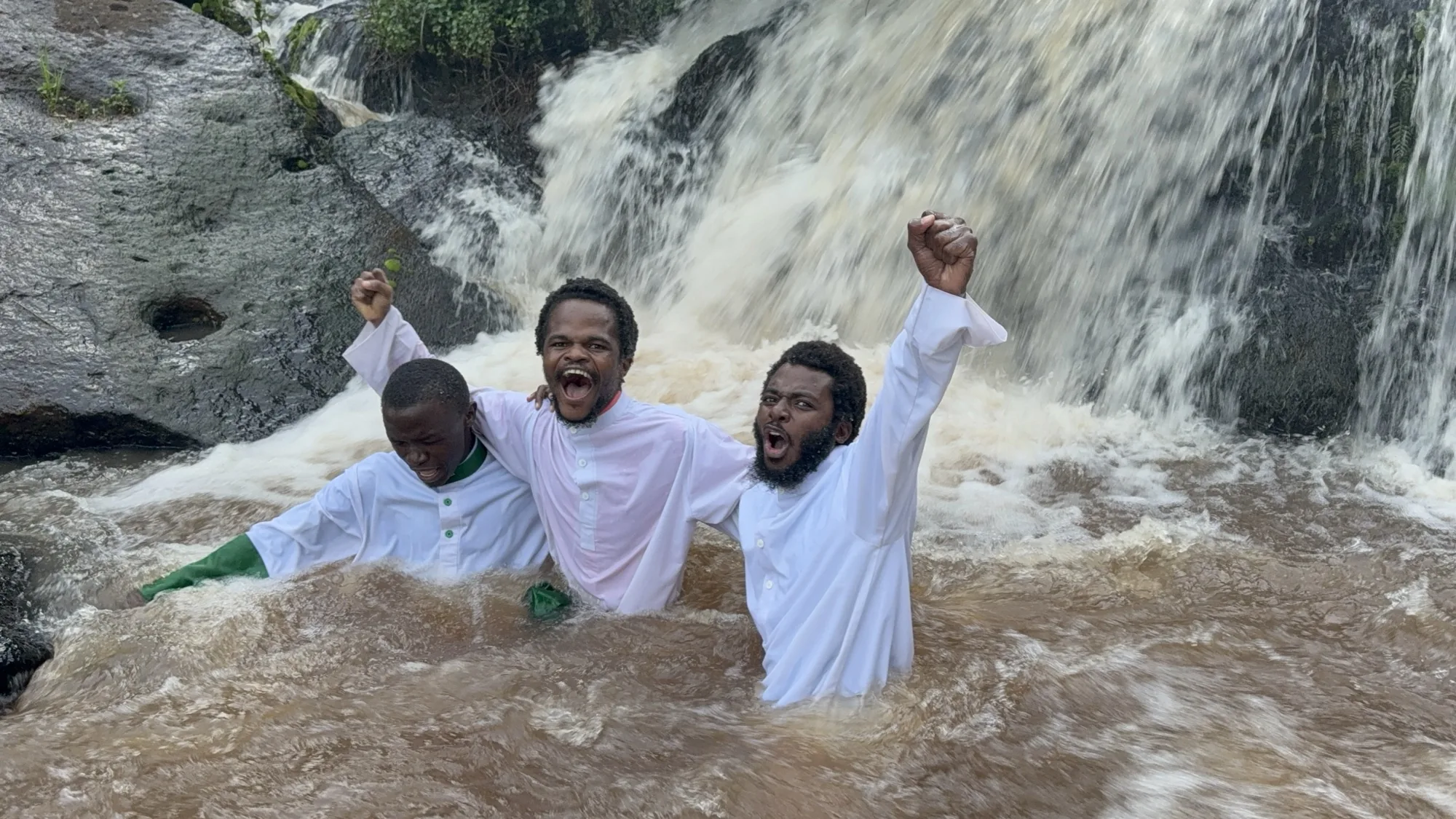 Ministers celebrate a baptism beneath the waterfall in Nairobi, Kenya